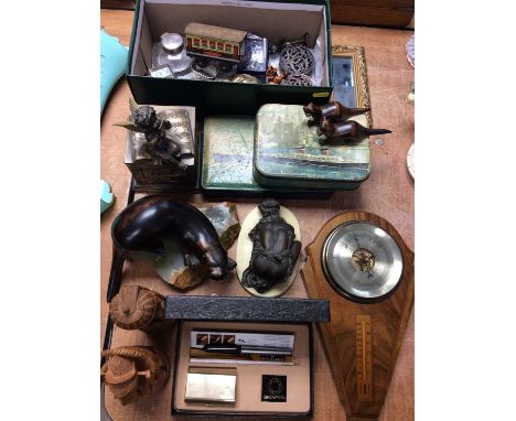 Wall barometer, wooden otter ornaments, old tins, leather map and sundries