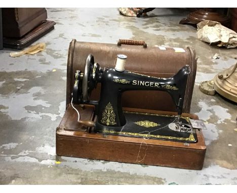 Three vintage sewing machines in cases including Singer