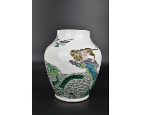 A Chinese Qing dynasty famille verte enamel vase, possibly Kangxi period, of baluster form with applied green, blue and auber