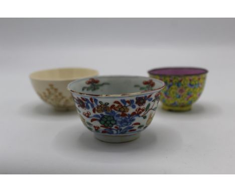 Three Oriental tea bowls to include an 18th century Chinese Wucai example decorated with yellow rabbits, flowers and foliage,