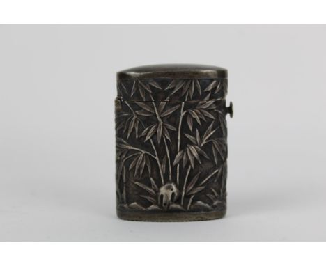A Chinese Qing, late 19th century silver vesta of oval form, embossed and chased with bamboo, unmarked 25g, 4.5cm high 