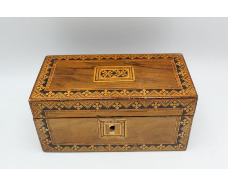 A 19th century Tunbridge ware walnut tea caddy decorated to the hinged lid and front with stylised flowers and V shaped motif