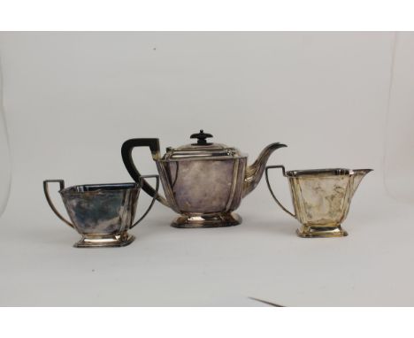 A mid 20th century three piece silver tea service by Atkin Brothers Sheffield 1940, comprising a teapot, a sugar bowl and cre