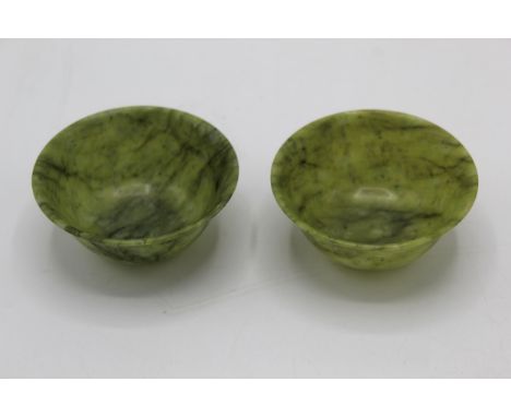 A pair of 20th century Chinese green jade coloured tea bowls, 4.5cm high, 7.5cm dia 