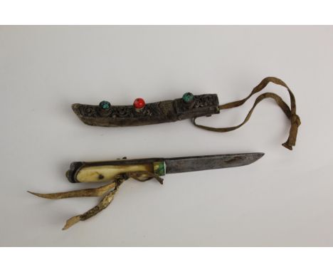A Tibetan Kampa woman's knife, first half twentieth century, the iron bladed knife with bone handle having brass mount in the