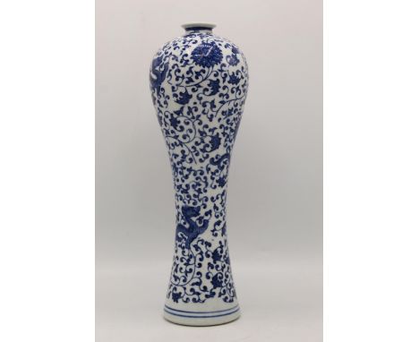 A late 20th century Chinese blue and white vase of waisted form decorated with three dragons, and a continuous design of larg