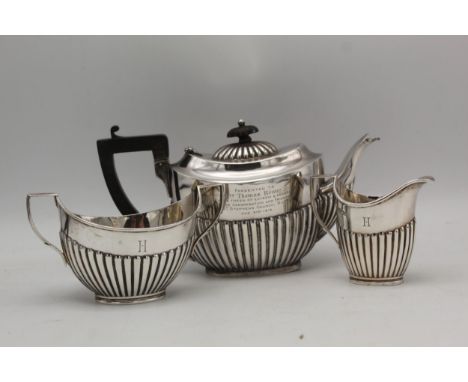 A matched Batchelors silver three piece tea service teapot by Josiah Williams &amp; Co London 1909 and the sugar bowl and cre