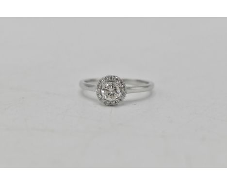 An 18ct white gold diamond ring having a central diamond 4.6mm dia, surrounded by a band of diamonds, stamped 750, 2.6 grams 