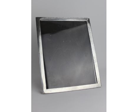 An early 20th century silver photograph frame by Turner & Simpson, Birmingham 1937, on an easel plywood back, 29cm high, 22cm