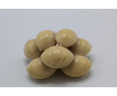 A 19th century Japanese ivory netsuke of eight Ginko nuts by Kiyokatsu, signed, 4.8cm long 