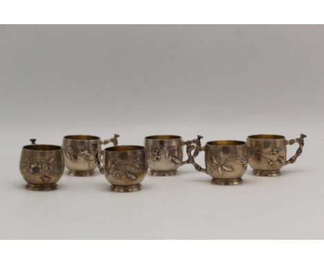 A set of six French silver Chinese style small cups, embossed and chased with a flowering branch and insect and a bamboo effe