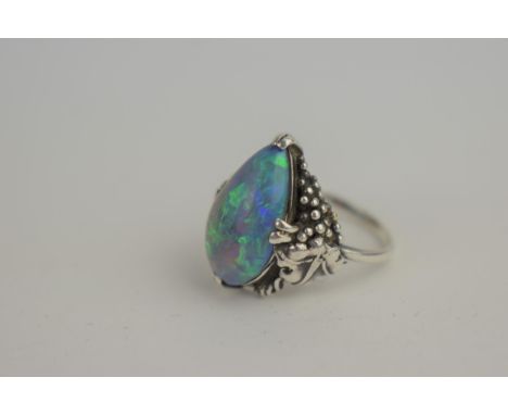 A tear-drop black five opal set in white metal, the shoulders decorated in the form of grapevine, total weight 4.62g Location