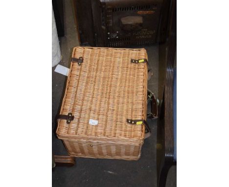 A wicker picnic hamper and contents