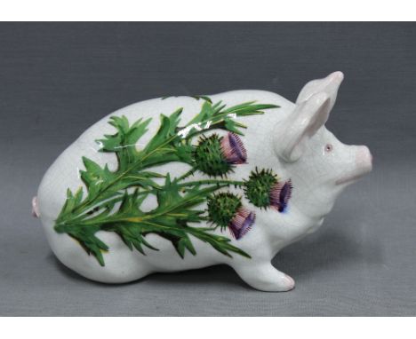 Wemyss Scottish pottery pig, hand painted with thistles pattern, (one front trotter lacking) (a/f) 17cm long 