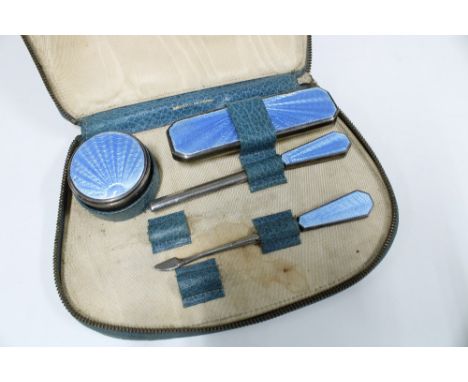 Asprey of London silver and blue enamel manicure set in original blue leather case, comprising circular pot, nail buffer and 
