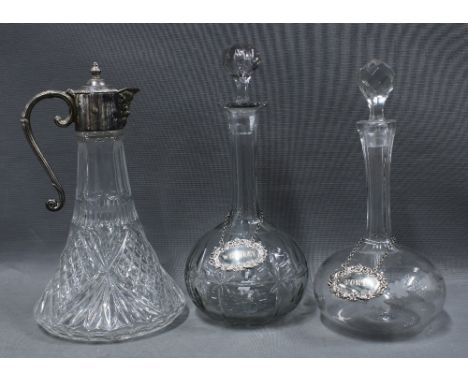 Two 19th century globe and shaft decanters with stoppers together with two Irish silver decanter labels, one for Whiskey and 