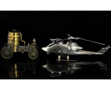 Two Novelty Cast Metal Tabletop Lighters The first in the form of a brushed metal Huey Cobra helicopter with rotating blades.