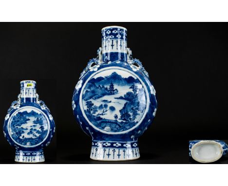 Chinese Blue And White Moon Flask Decorated with pagoda's and landscape scenes, with stylised dragon handles and cherry bloss