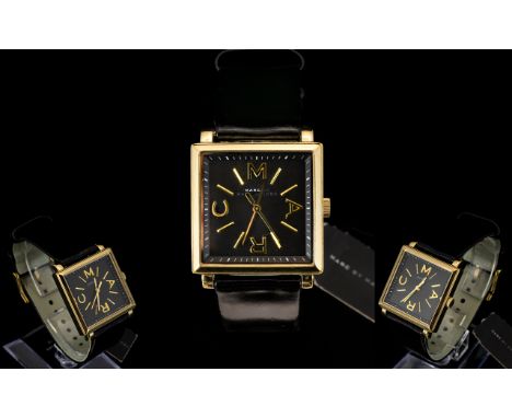 Marc Jacobs - Trueman Collection MBM1279 Ladies Black Leather Strap - Gold Tone Cased Wrist Watch. Features Square Black Dial