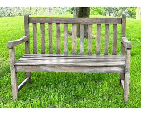 GARDEN BENCH, well weathered teak of slatted and pegged construction with shaped arms, 120cm W. 