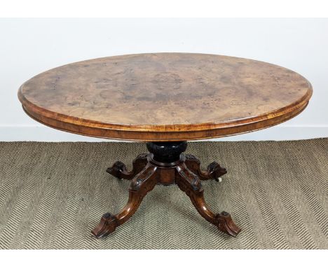 LOO TABLE, mid Victorian burr walnut and walnut with oval tilt top and ceramic castors, 73cm H x 135cm W x 98cm D. 