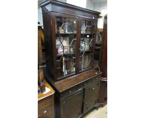 Early 20th Century mahogany bookcase in George III style with a moulded cornice above a pair of astragal glazed doors, three 