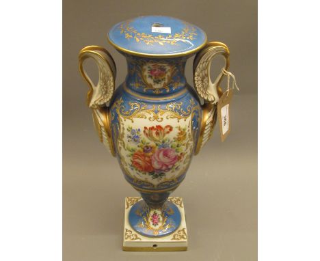 Early 20th Century French porcelain table lamp in the form of a two handled pedestal urn, 12.75ins high (at fault) 