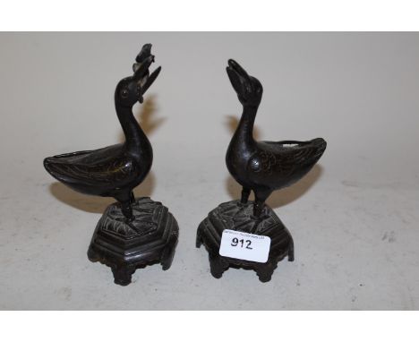 Pair of 19th Century Chinese bronze figures of ducks, 7ins high (slight damages)One foot on plinth missing and flower from be