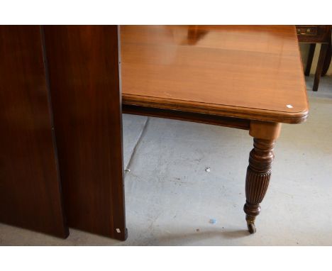 Late 19th Century walnut rectangular wind-out extending dining table, the moulded top above a moulded frieze, raised on turne