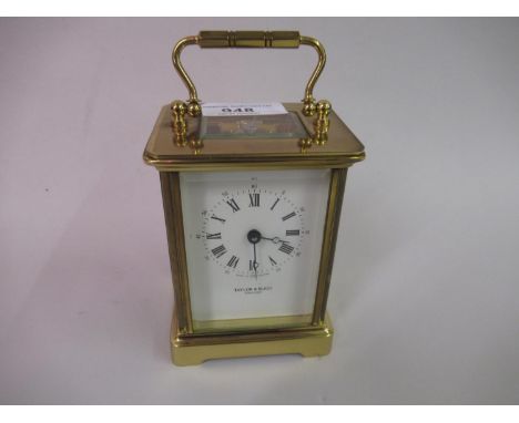 20th Century gilt brass carriage clock, the enamel dial with Roman and Arabic numerals, inscribed Taylor and Bligh, England 