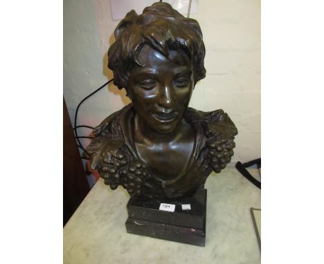 Brown patinated bronze bust of a boy with grape vine collar mounted on a composite pedestal base, signed indistinctly, 22ins 