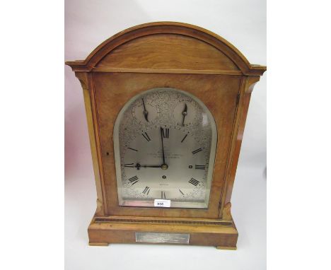 Late Victorian walnut bracket clock by Dent, London, the architectural case with an arched door and fretwork side panels, the