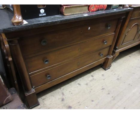 19th Century French walnut commode, the black marble top above three graduated drawers with brass knob handles flanked by tur