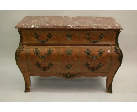 Late 19th or early 20th Century French kingwood parquetry commode, the rouge flecked marble top above three drawers, the bomb