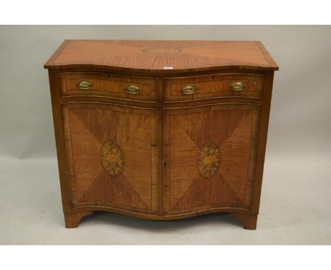 Edwardian satinwood crossbanded and floral inlaid side cabinet, the serpentine front with two drawers above two doors on brac