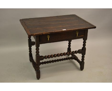 17th Century oak side table, the plank top above a single drawer, raised on bobbin turned supports with stretchers, 33.5ins w