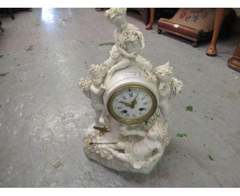 19th Century Meissen blanc de chine mantel clock mounted with figures of cherubs with grapes and a wine goblet, the circular 