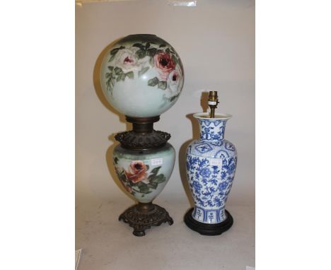 Gilt metal mounted opaque glass oil lamp decorated with roses, together with a modern Chinese blue and white floral decorated