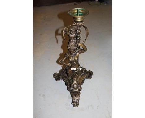 20th Century patinated brass candle stand / lamp base in the form of a putti riding a mermaid with ornate tri-form base, 30in