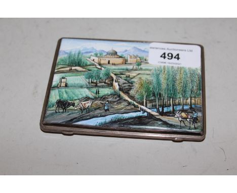 Middle Eastern white metal and enamel cigarette case, the lid decorated with an extensive landscape, the reverse with two fig