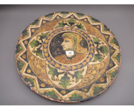 Large Continental terracotta wall plate incised with a portrait within floral borders 