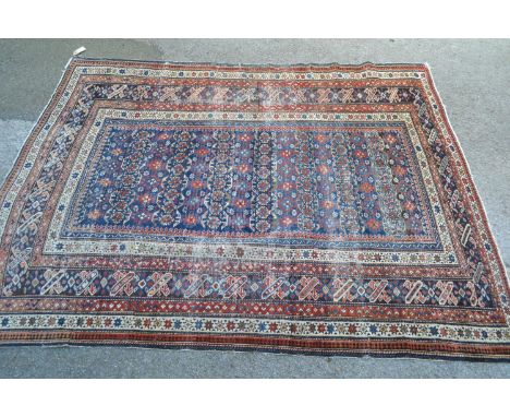 Shirvan rug with blue ground repeating rosette centre panel and multiple borders (various areas of wear), 6ft 6ins x 4ft 8ins