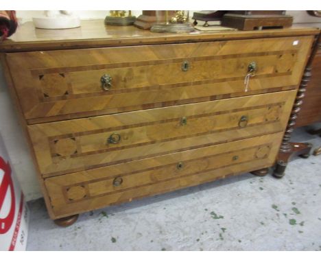 18th Century Italian walnut and inlaid commode, the moulded top above three drawers with brass handles and escutcheons on bun