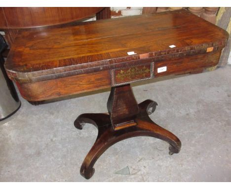 Regency rosewood fold-over card table with a square baluster column support and quadruped base (at fault) 