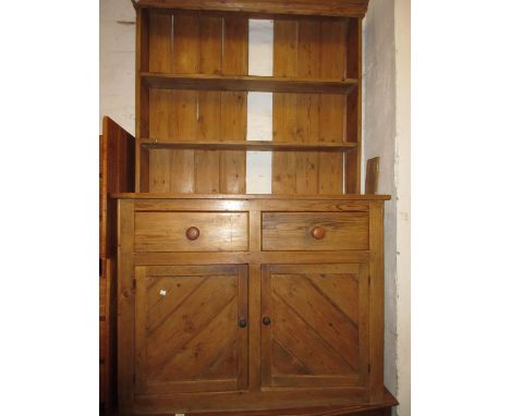 Small Victorian stripped pine dresser, the boarded shelf back above two drawers and two panelled doors, 48ins wide, 76ins hig