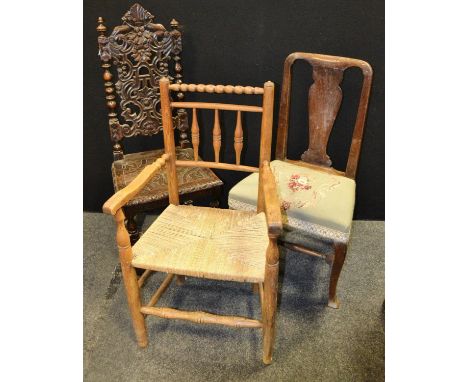 A Victorian oak side chair,  heavily carved back, carved seat, H stretcher, c.1880;  a Country Kithchen elbow chair, rush sea