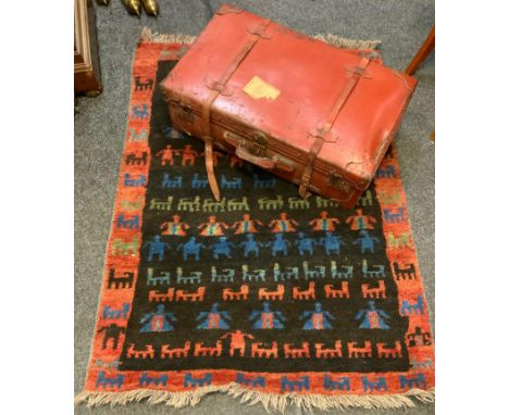 A vintage leather traveling trunk case, metal catches, twin banded straps, 77cm x 44cm;  a Persian Gabeh rectangular handmade