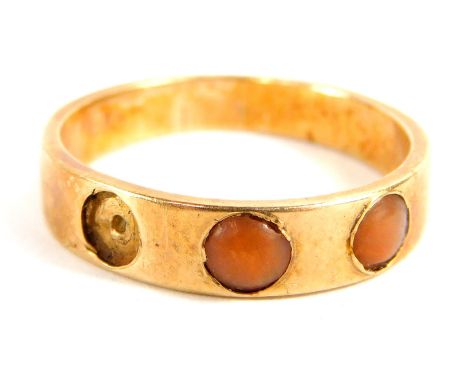 A Victorian coral set dress ring, with three stone set design (one missing), on a yellow metal band, unmarked, ring size M, 2
