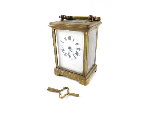 An early 20thC brass carriage clock, the white enamel rectangular dial with rubbed detailing marked Spalding, dial bearing Ro