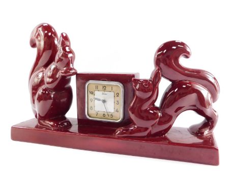 A French mid pottery mantel clock, scout square dial bearing Arabic numerals, clockwork movement, the square clock case flank